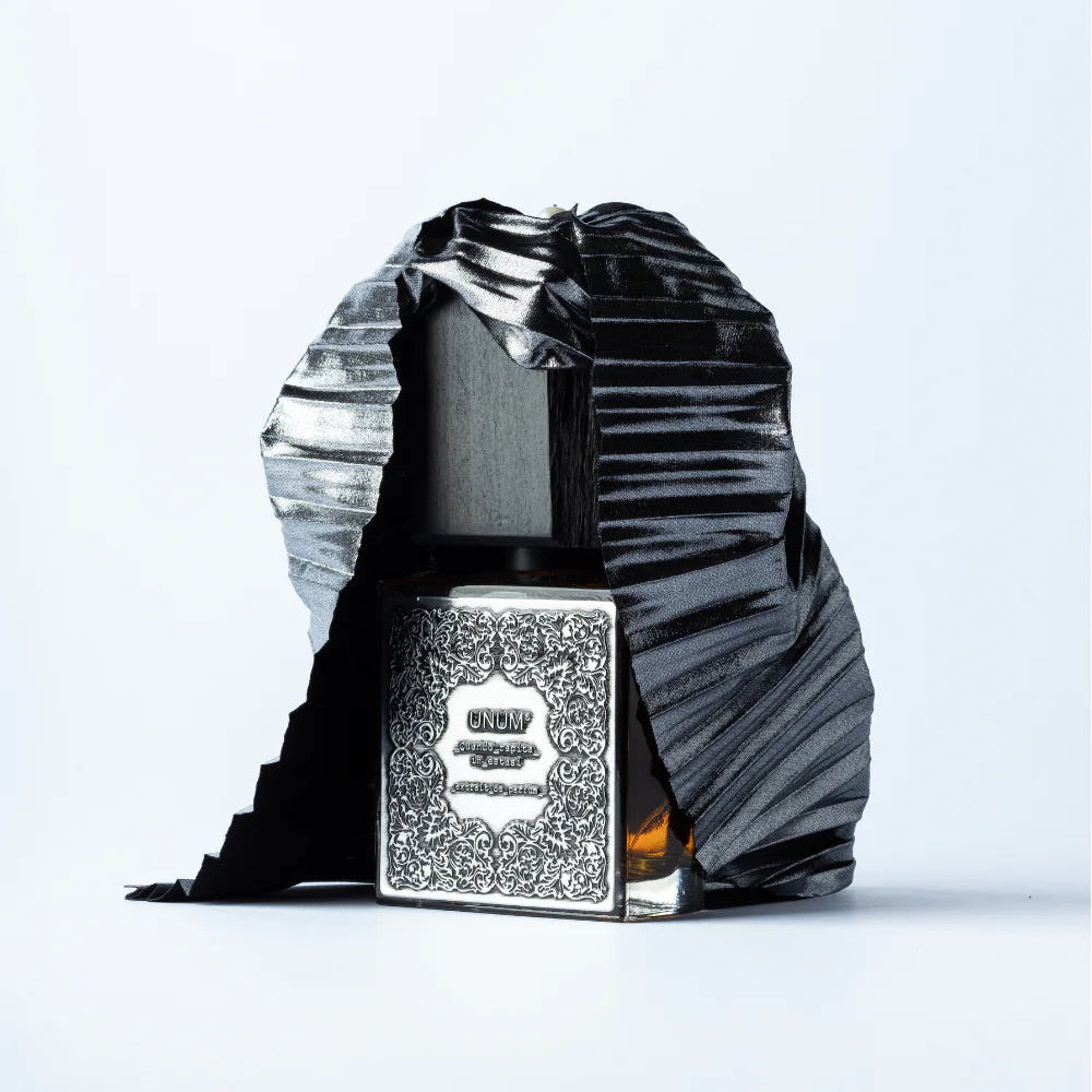 Luxury bottle with decorative cap on a light gray background