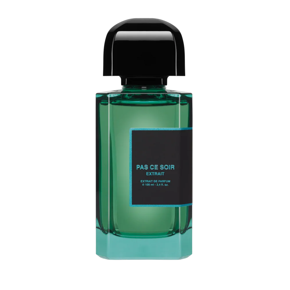 Green perfume bottle with black cap on a white background