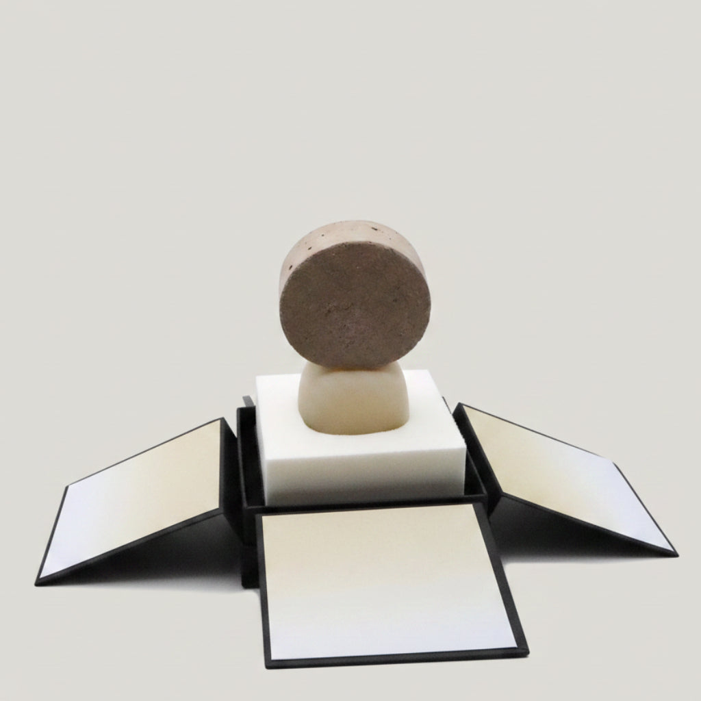 Ceramic ring on a stand with a decorative box in the background
