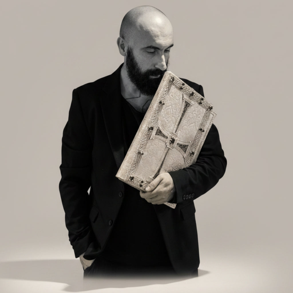 Man holding a decorative box with intricate design against a black background