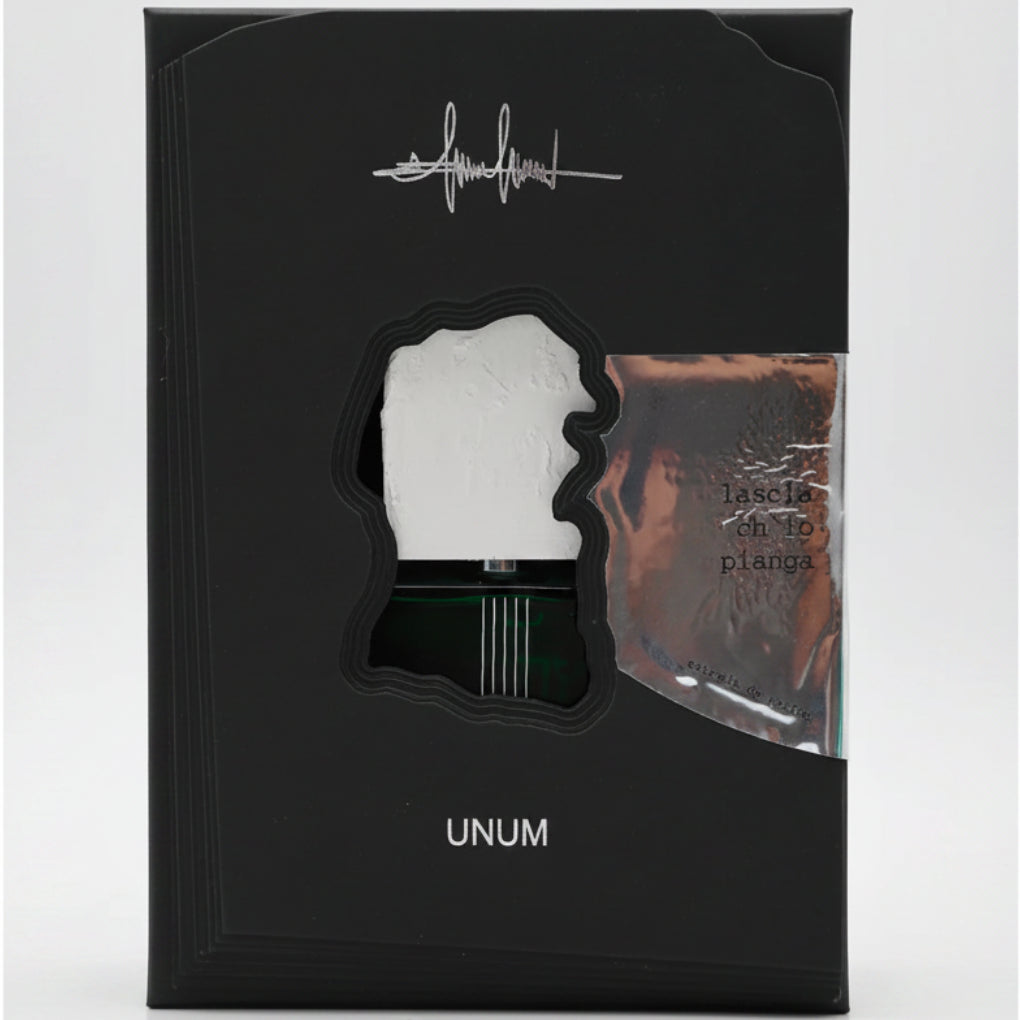 Black packaging with a cutout of a face and 'UNUM' branding on a white background