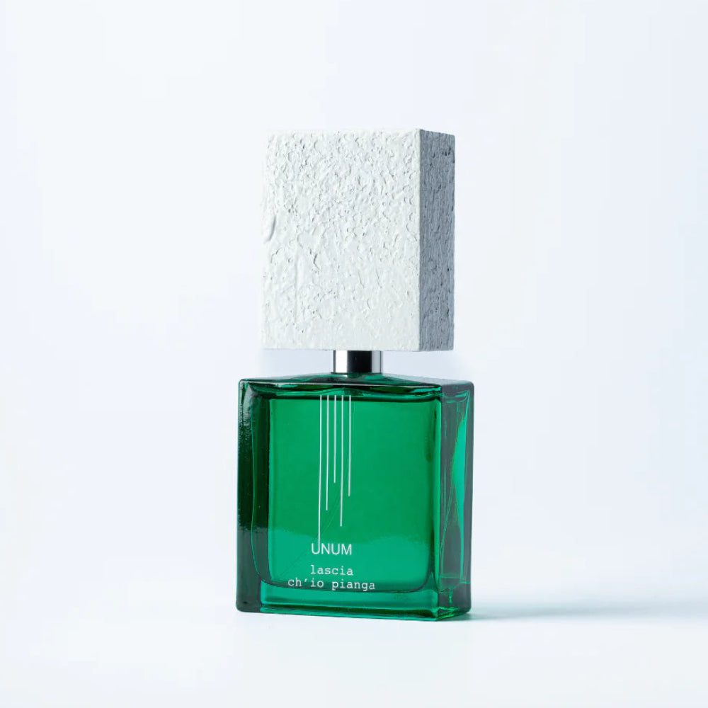 A green rectangular perfume bottle with a textured light gray cap, shown on a clean white background.