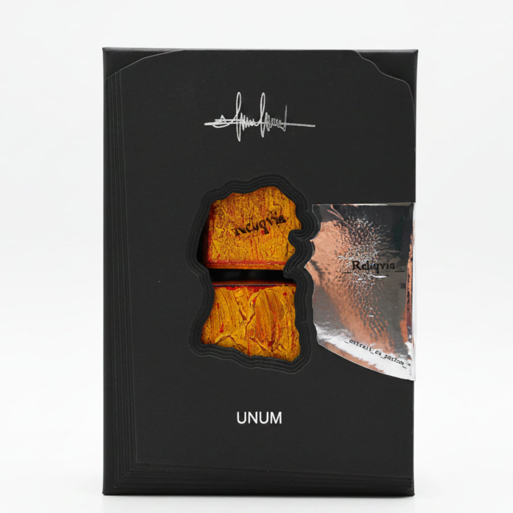 Black packaging with gold and silver elements, featuring the brand 'UNUM'.