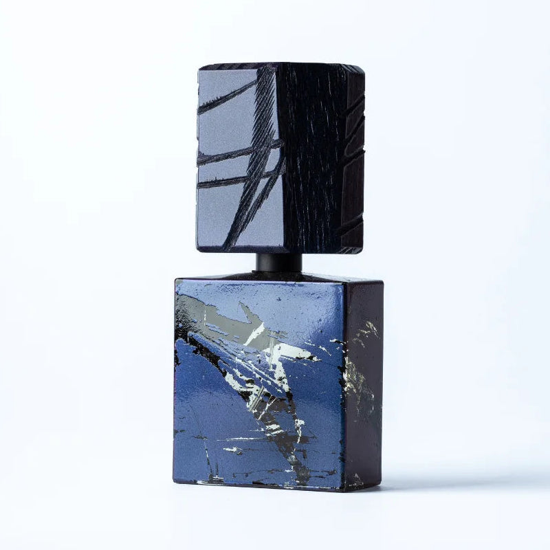 Perfume bottle with black and blue design on a white background
