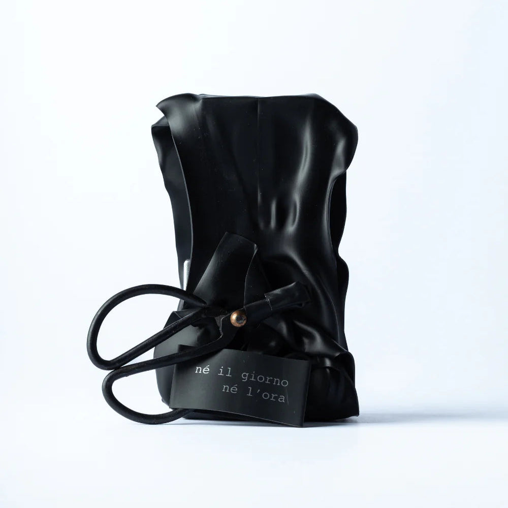 Black leather drawstring bag with text on a white background